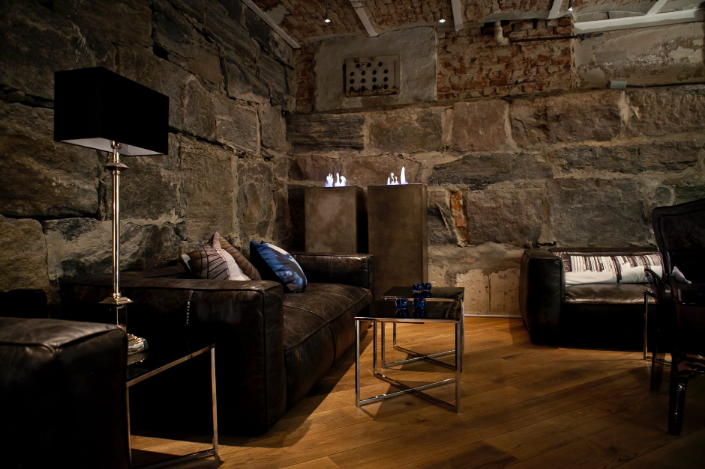 a cozy room with stone walls
